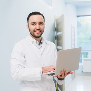 Portrait Of Doctor Holding Laptop, Indoors at hospital